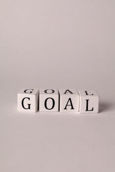 Simple motivation concept with 'Goal' spelled on white cubes against a neutral background.